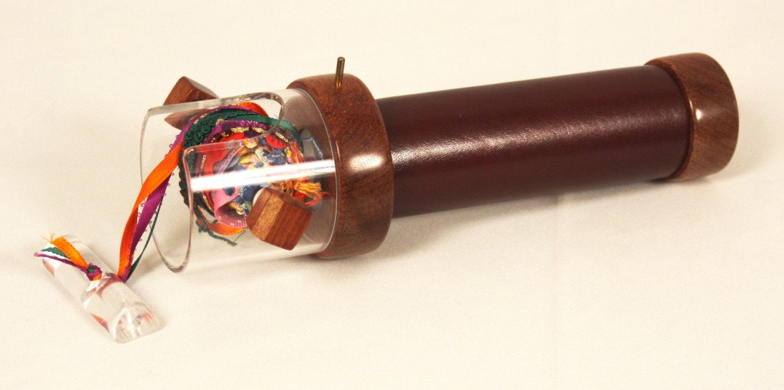Vintage Kaleidoscope NS158: Vintage Kaleidoscope NS158. Great Condition! JL11AU. This vintage kaleidoscope is constructed of wood, leather, acrylic and ribbons. Condition: chipped on one corner. Measures 10 x 3". Thank you for v