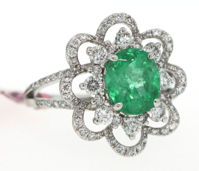 18KT White Gold 2ct Emerald and Diamond Flower Ring FJM: 18KT White Gold 2ct Emerald and Diamond Flower Ring FJM760. Excellent Condition! TN1922GA. One 18KT white gold H. Emperor emerald and diamond flower designed ring. Features one oval cut emerald weighi