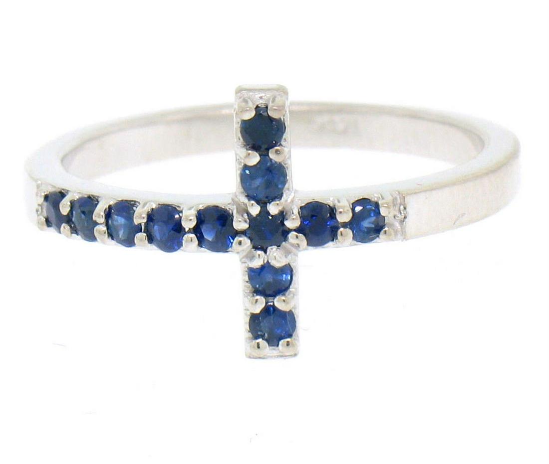 NEW 14k White Gold 0.25 ctw Round Cut Rich Blue Sapphire Curved Cross Band Ring: A new solid 14k white gold cross band ring, with 12 round brilliant cut natural sapphires (0.25ctw). The ring is size 6.0, weighs a total of 2.3 grams, and measures 11.0mm wide.