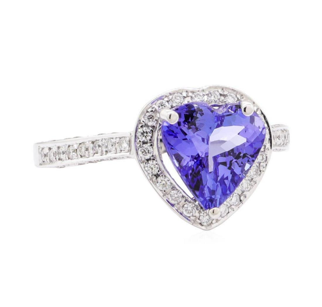 2.61 ctw Tanzanite and Diamond Ring - 14KT White Gold: One electronically tested 14KT white gold lady's cast fashion ring with a basket halo with cathedral shank with a bright polish finish. The featured lady's ring has a shank measuring 1.70 millimeters 