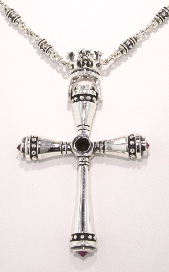 Polished Sterling Silver and Ruby Cross Pendant GD296: Polished Sterling Silver and Ruby Cross Pendant GD296. Excellent Condition! HJ152SW. One polished sterling silver and ruby cross pendant and chain. Ends in a toggle clasp. Chain measures approximately