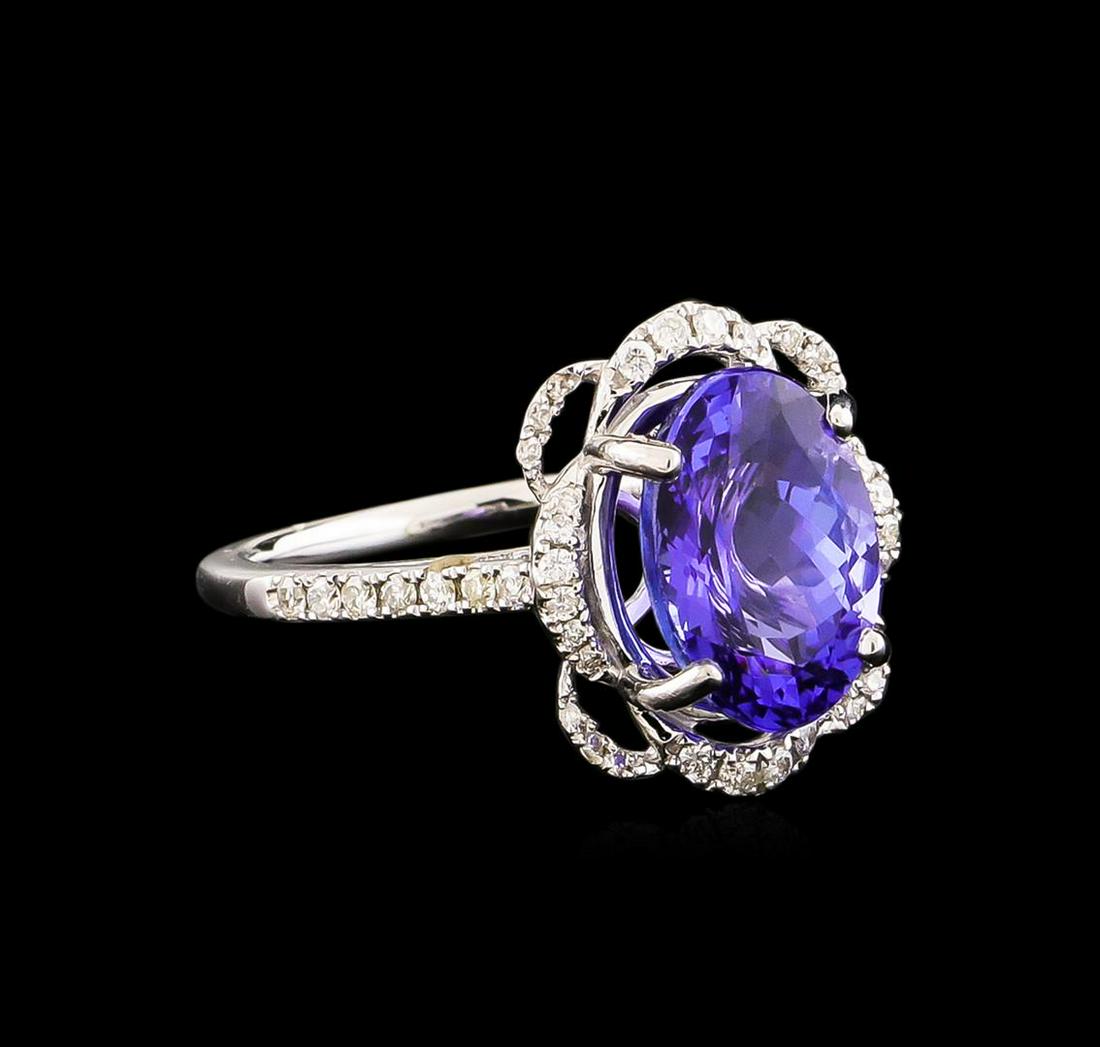 14KT White Gold 3.09 ctw Tanzanite and Diamond Ring: One electronically tested 14KT white gold ladies combination cast & assembled ring with a bright polish finish. Condition is new. Identified with markings of "14K". Containing: One prong set oval modi