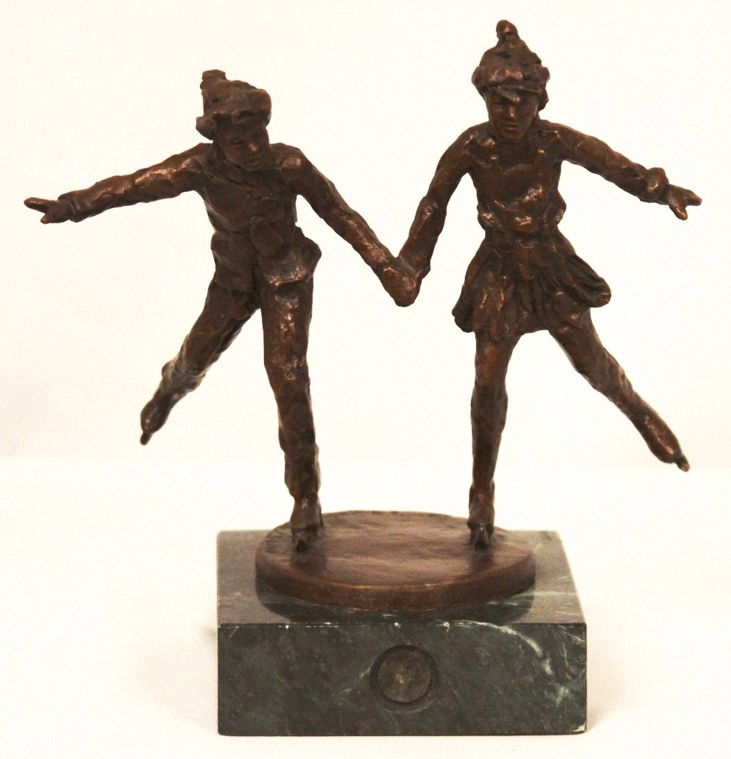 "Together on the Glass" by Dennis Smith Bronze Statue B: Together on the Glass" by Dennis Smith Bronze Statue BD220. Excellent Condition! LZ16CT. This sculpture represents a boy and girl trying out their new skates. It is from Salt Lake 2002 Olympic Dreams 