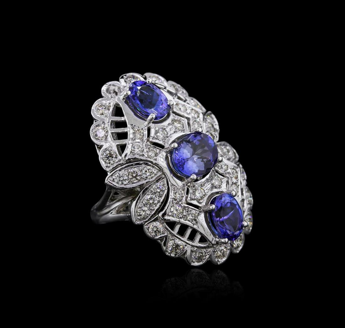 14KT White Gold 3.96 ctw Tanzanite and Diamond Ring: One electronically tested 14KT white gold ladies cast tanzanite and diamond ring with a split shank with a bright polish finish. Identified with markings of "K14". Condition is new. Containing: Three 
