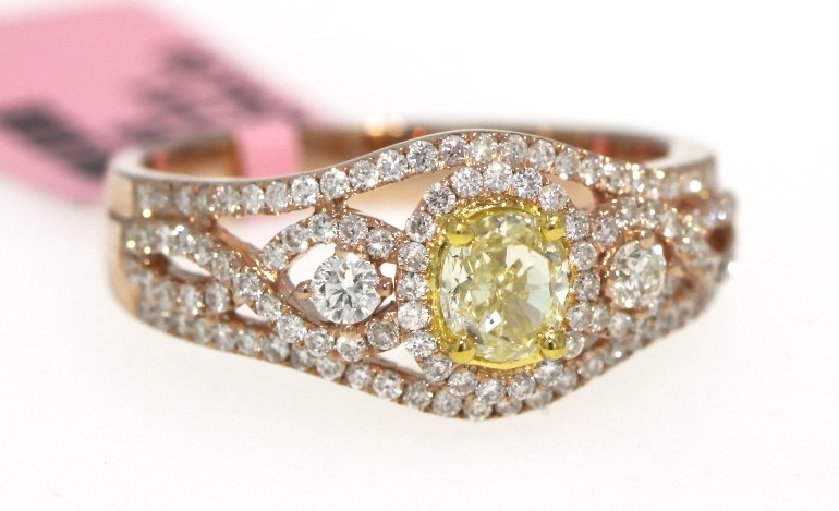 18KT Rose Gold .52ct Yellow and .6ct White Diamond Ring: 18KT Rose Gold .52ct Yellow and .6ct White Diamond Ring FJM853. Excellent Condition! DU4241GF. One 18KT rose gold yellow and white diamond ring. Features one fancy yellow diamond weighing 0.52cts surr
