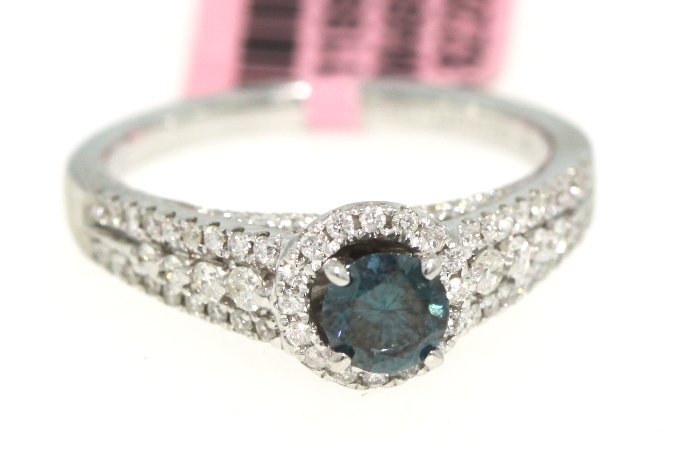 18KT White Gold Blue and White Diamond Ring FJM1205: 18KT White Gold Blue and White Diamond Ring FJM1205. Excellent Condition! HS228GD. One 18KT white gold blue and white diamond ring. Features one center blue diamond weighing 0.44cts and 94 white round