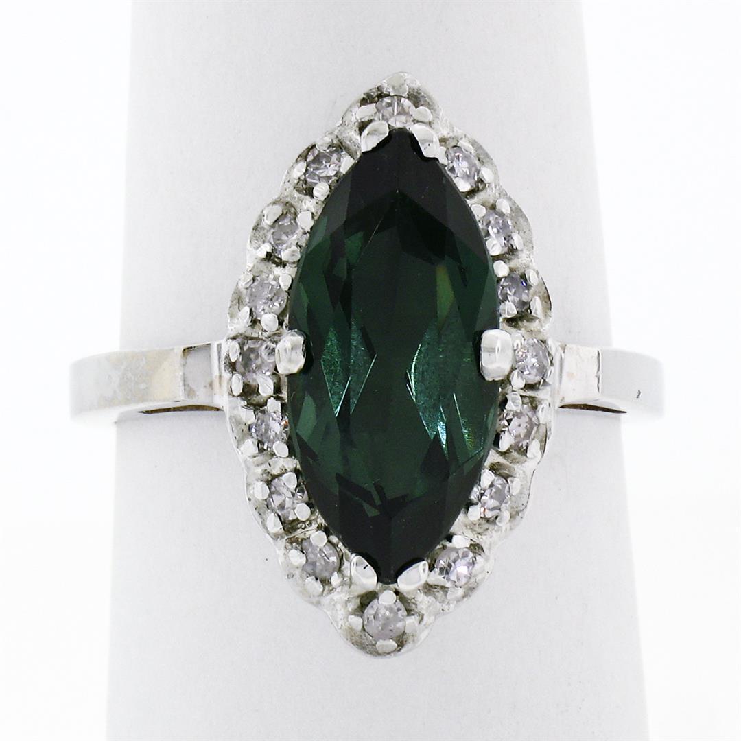 Vintage 14K White Gold 2.72 ctw Marquise Cut Green Tourmaline & Diamond Halo Rin: A vintage solid 14k white gold solitaire ring, with1 marquise cut natural tourmaline (15.2x7.4mm- 2.50ct ), surrounded with a halo of 16 old single cut natural diamonds (G/H- VS2/SI1; 0.22ctw). The ri