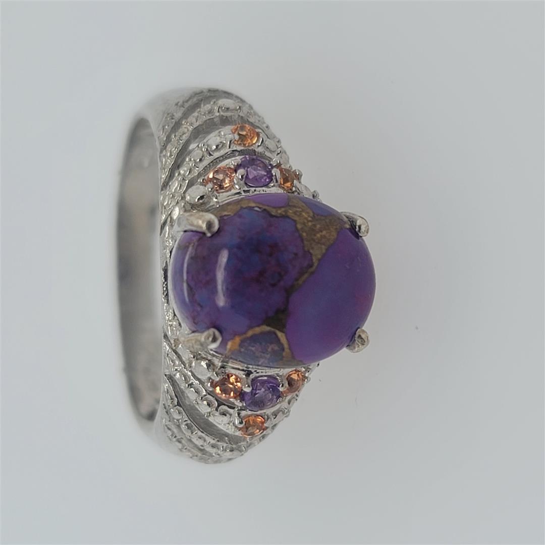 Sterling Silver Ring: One Sterling Silver Ring. The ring size is 10. Contains semiprecious stones.