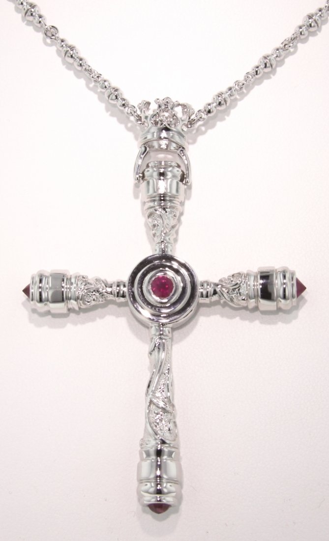 Polished Sterling Silver and Ruby Cross Pendant GD298: Polished Sterling Silver and Ruby Cross Pendant GD298. Excellent Condition! WE162CL. One polished sterling silver and ruby cross pendant and chain. Ends in a toggle clasp. Chain measures approximately