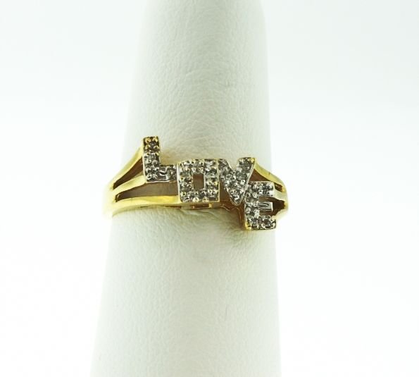 10KT Yellow Gold "Love" Diamond Ring .25ct GD72: "10KT Yellow Gold "Love" Diamond Ring .25ct GD72. Good Condition! FV87WH. One 10KT yellow gold "Love" diamond ring weighing 2.6g. The word "LOVE" is embellished with diamonds weighing 0.5ctw. Identifi