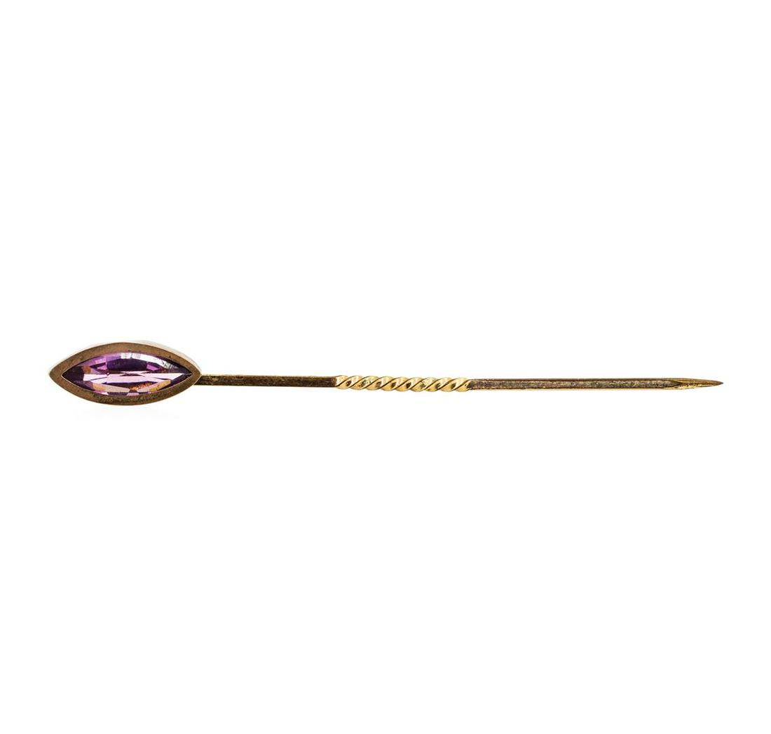 Purple Crystal Stick Pin - Yellow Gold Plated: One yellow gold plated stick pin weighing 0.7 grams containing one purple crystal.