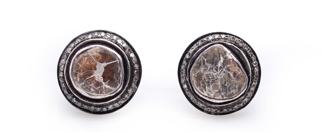 Antique Indian Gold Topped Silver & Diamond Earrings: A pair of antique Indian gold topped silver polki diamond earrings with ornate backs mounted as studs, each with a large diameter single diamond in a bezel with a surround of single cut diamonds formi
