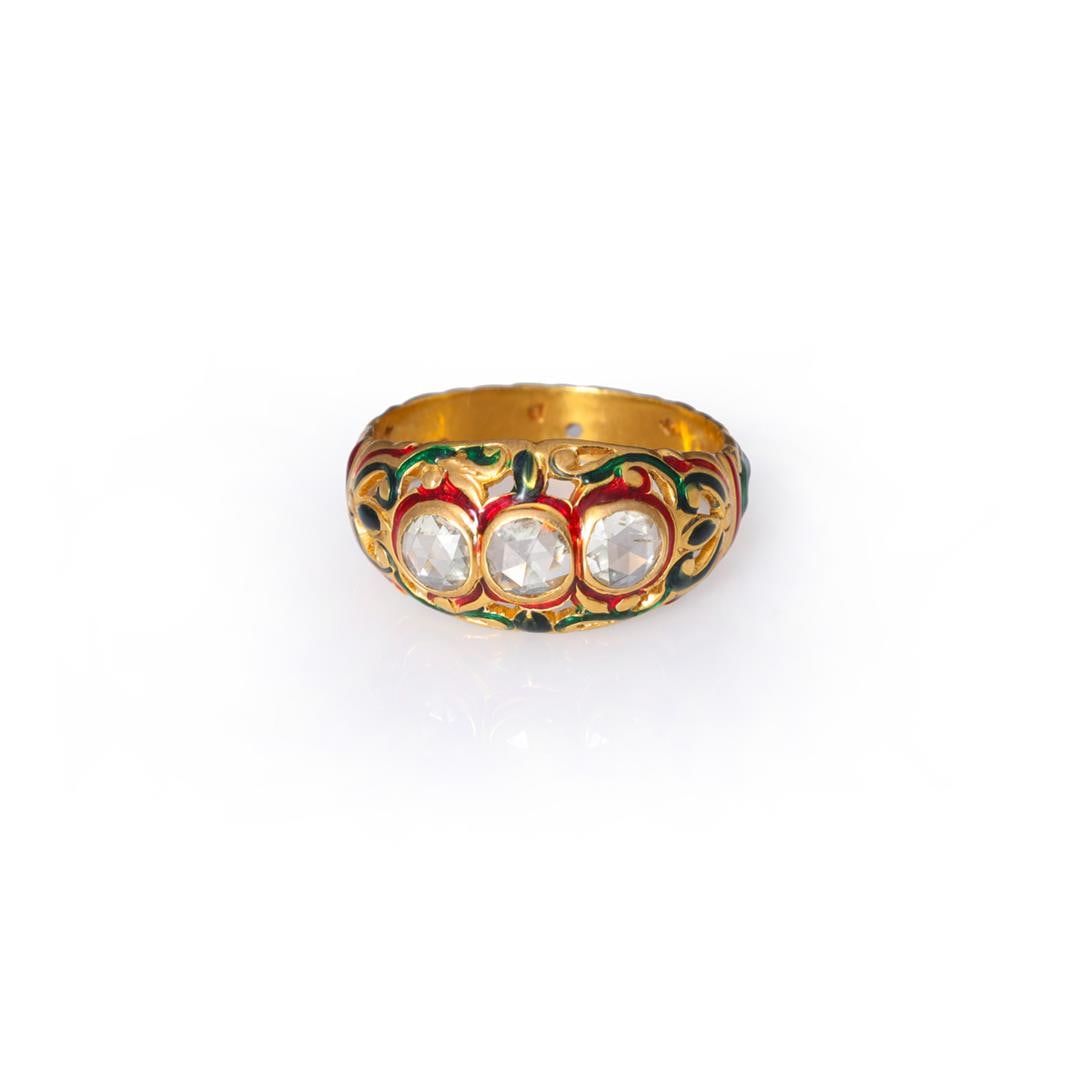 Vintage Southeast Asian 22k Yellow Gold & Enamel Diamond Ring: A vintage 22k yellow gold and diamond ring; bezel set with three round rose cut diamond measuring approximately .20 carats each, surrounded on top with red enamel borders, the gold band deeply engrave