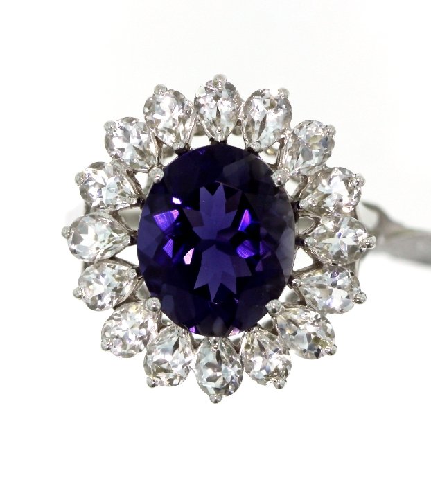 10KT White Gold 4.85ct Iolite & Sapphire Ring A3943: 10KT White Gold 4.85ct Iolite & Sapphire Ring A3943. Excellent Condition! IJ931YQ. One ladies' iolite and sapphire ring, stamped and tested 10KT white gold, containing 1 oval cut iolite and 16 pear sh