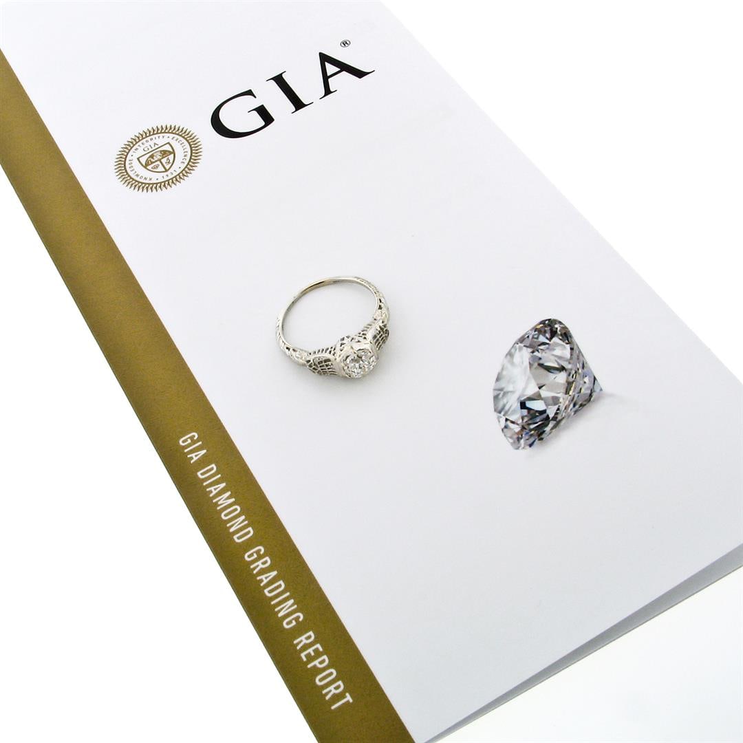Antique Art Deco 18k Gold 1.03 ctw GIA European Diamond Filigree Engagement Ring: An art deco period solid 18k white gold filigree engagement ring with 1 GIA certified old European cut natural diamond (I - SI2; 1.03ct). The ring is size 9.0, weighs a total of 2.70 grams, and measur