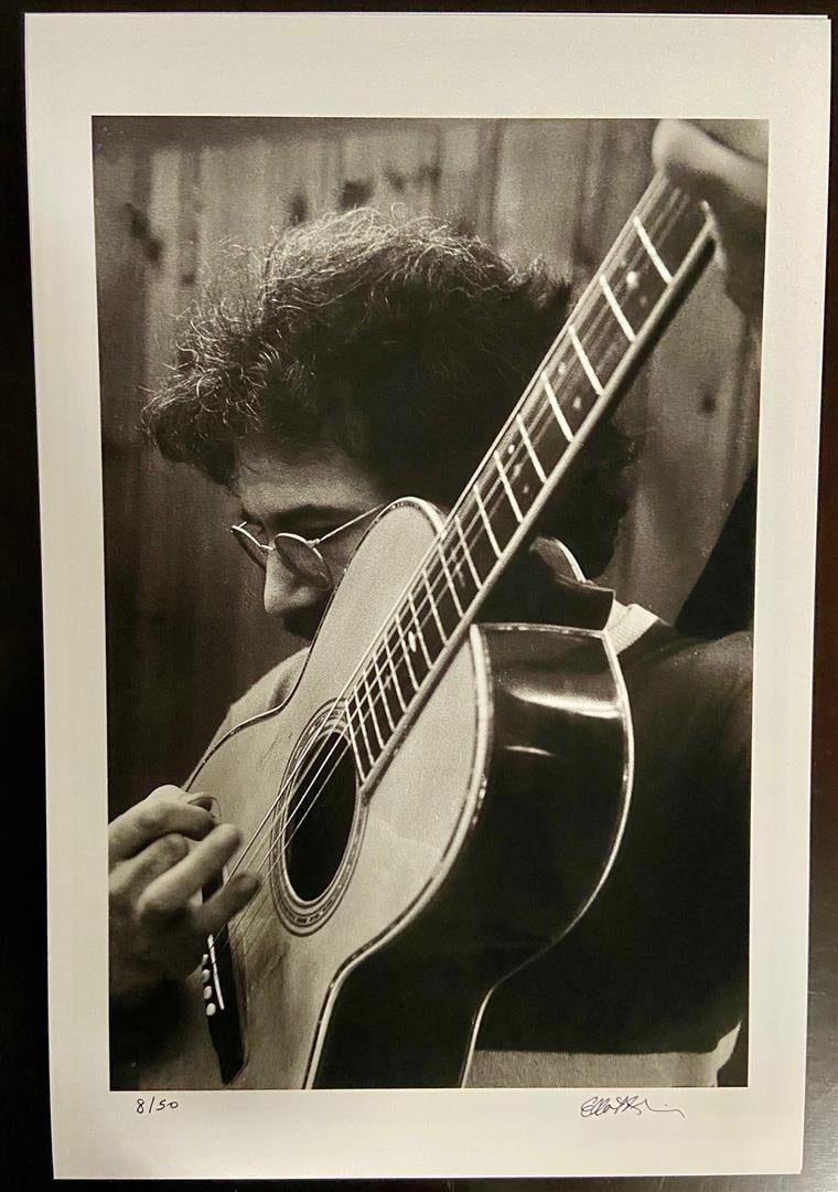 Jerry Garcia w/ Big Guitar by Elliot Blinder: A s/n 14.5x 9.5" image on 18x12" paper of Jerry Garcia tuning his guitar backstage at The Boston Tea Party in 1969.By Rolling Stone Photographer Elliot Blinder.