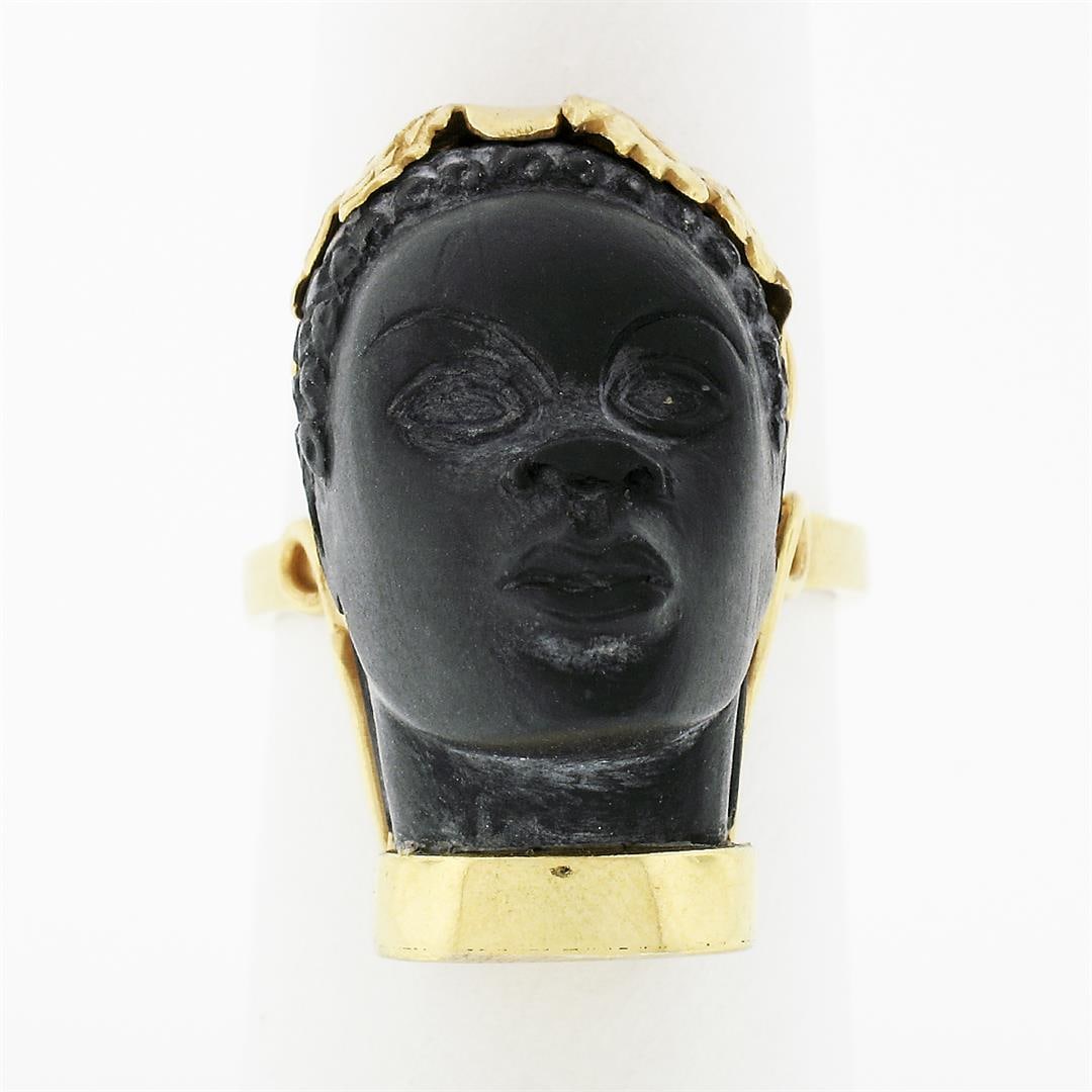 Vintage 14k Yellow Gold Carved Face Detailed Blackamoor Ring w Open Work Setting: A vintage solid 14k yellow gold ring, with 1 carved natural blackmoor (20.7x14.5mm). The ring is size 7, weighs a total of 11.69 grams, and measures 25.3mm wide.