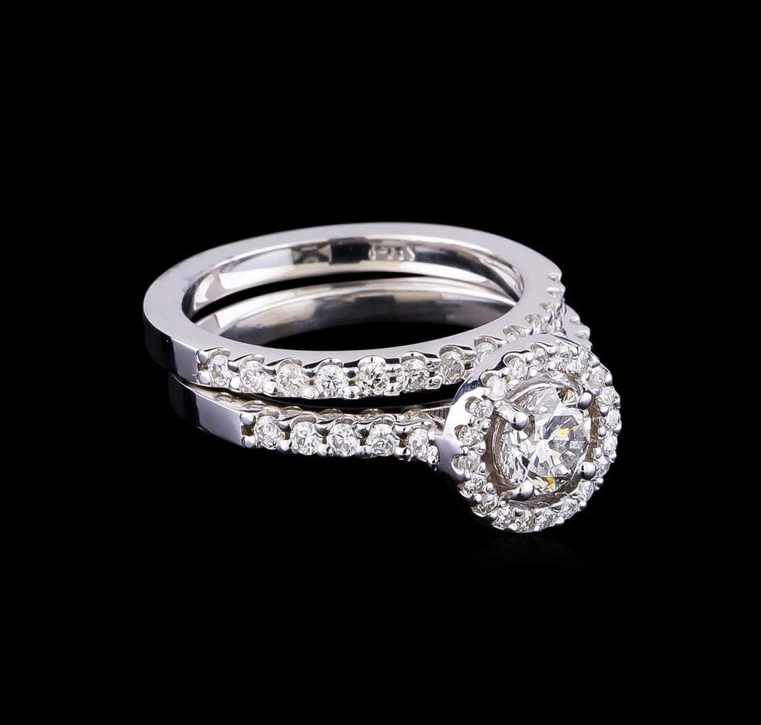 1.23 ctw Diamond Wedding Ring Set - 14KT White Gold: One electronically tested 14KT white gold lady's cast wedding set rings with a halo with a bright polish finish. The featured lady's ring set has a double shank measuring 4.11 millimeters in width. Id