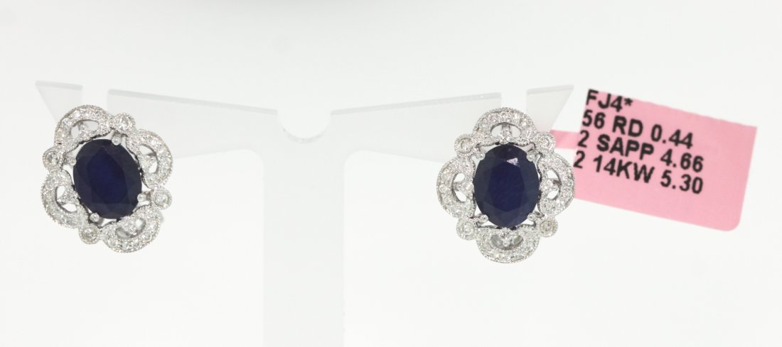 14KT White Gold 4.66ct Sapphire and Diamond Earrings FJ: 14KT White Gold 4.66ct Sapphire and Diamond Earrings FJM1177. Excellent Condition! VF166DP. One 14KT white gold sapphire and diamond earrings. The pair features two oval cut sapphires weighing a total