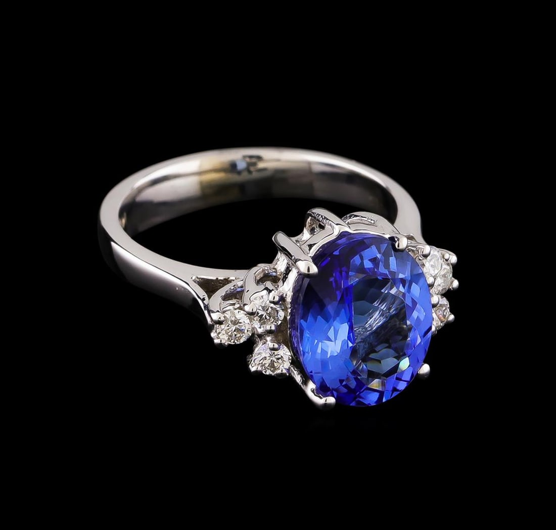 3.05 ctw Tanzanite and Diamond Ring - 14KT White Gold: One electronically tested 14KT white gold lady's cast fashion ring with a basket setting with a bright polish finish. The featured lady's ring has a shank measuring 3.36 millimeters wide. Identified w