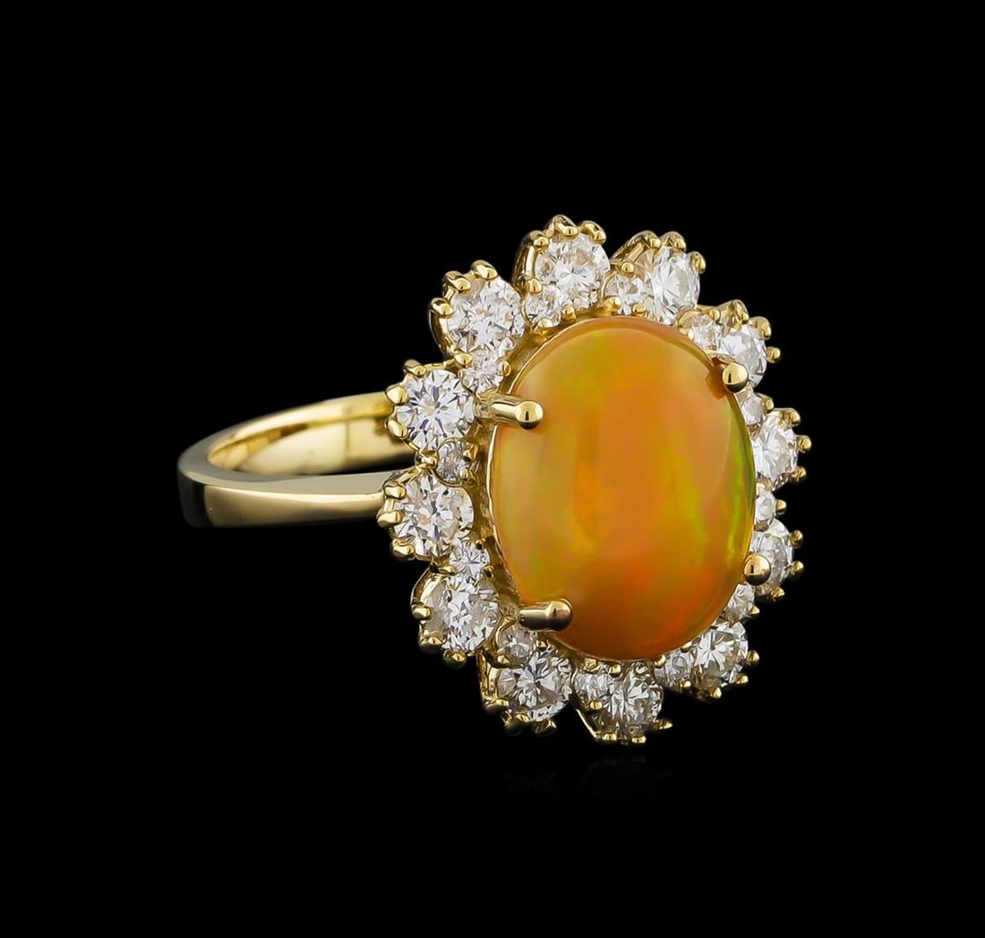 2.55 ctw Opal and Diamond Ring - 14KT Yellow Gold: One electronically tested 14KT yellow gold lady's cast fashion ring with a double basket halo with a bright polish finish. The featured lady's ring has a shank measuring 2.61 millimeters wide. Identif