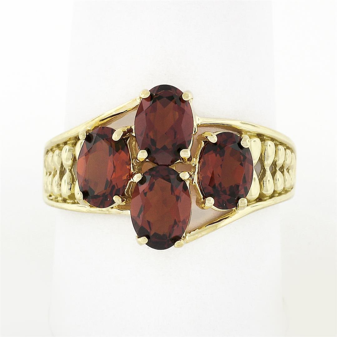 10k Yellow Gold 3.50 ctw Prong Set Oval Cut Garnet Open Work Sides Wide Band Rin: A vintgae solid 10k yellow gold wide band ring, featuring 4 oval cut natural garnets (7x5mm - 3.50ctw). The ring is size 10.0, weighs a total of 4.18 grams, and measures 14mm wide.