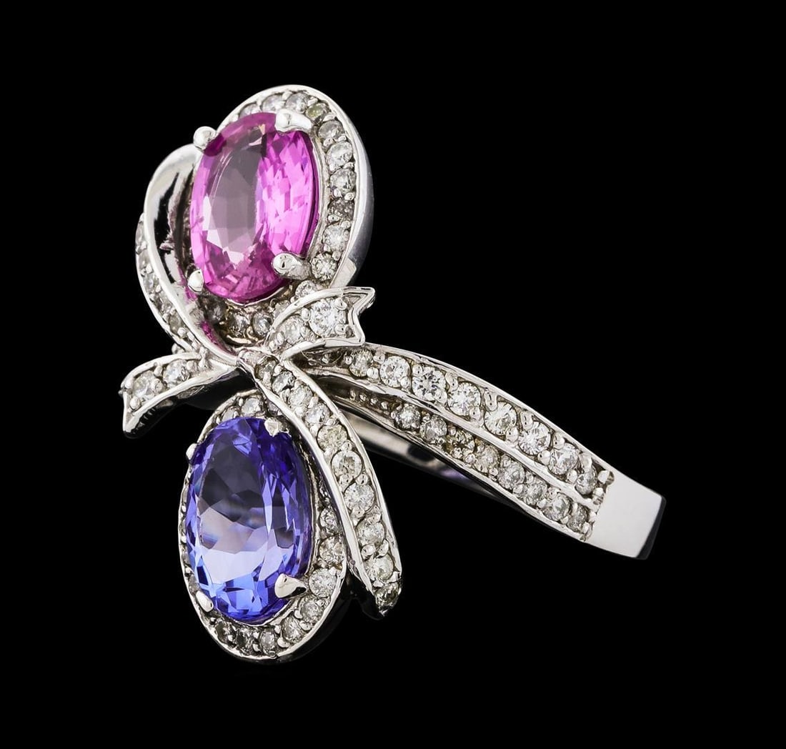 2.55 ctw Tanzanite, Pink Sapphire, and Diamond Ring - 14KT White Gold: One electronically tested 14KT white gold lady's cast fashion ring with a bypass shank with a bright polish finish. The featured lady's ring has an overlapping bow motif and a shank measuring 2.49 mil