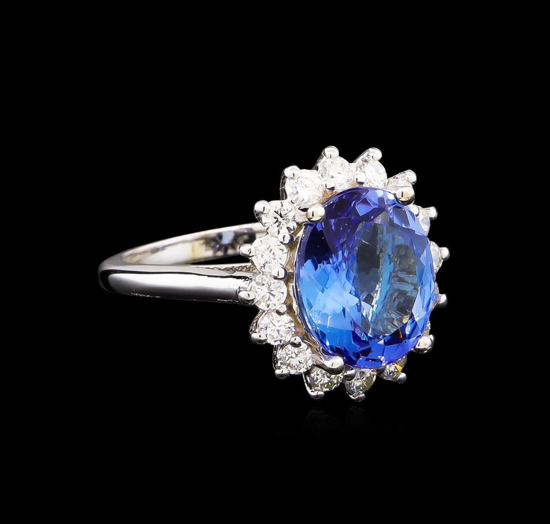 5.04 ctw Tanzanite and Diamond Ring - 14KT White Gold: One electronically tested 14KT white gold lady's cast fashion ring with a basket halo with a bright polish finish. The featured lady's ring has a shank measuring 2.15 millimeters wide. Identified with