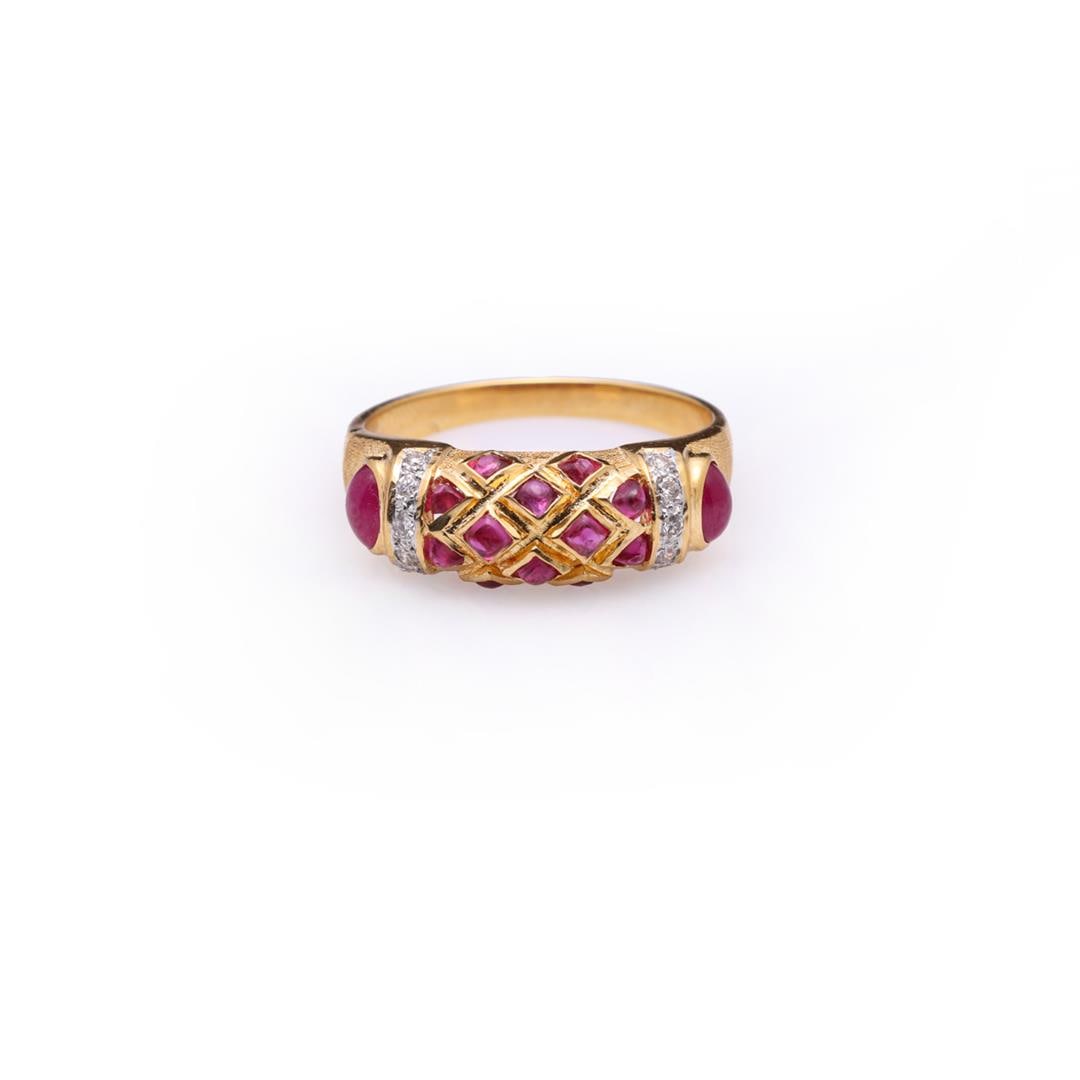 Ruby Cabochon & Diamond Dress Ring: Fine and delicate ring; a central bar on top with platted lozenges set with small cabochon rubies, each side with decorative diamond borders and each shoulder with a bezel set cabochon ruby on a bark 