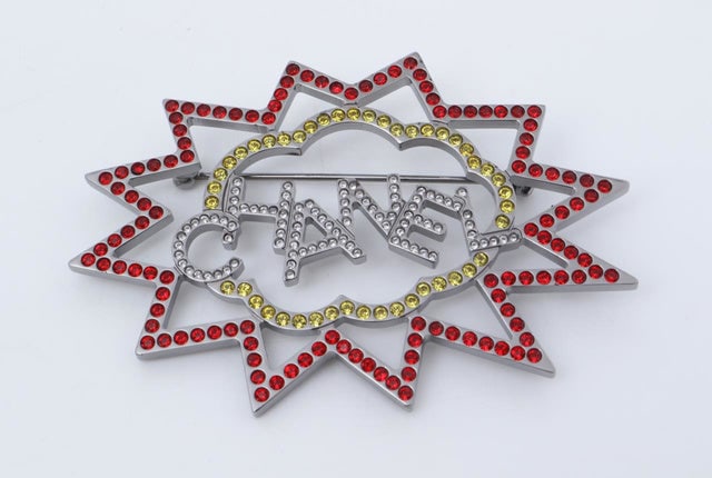 Chanel Red and Yellow Ruthenium Crystal CC Brooch: One Chanel Red and Yellow Ruthenium Crystal CC Brooch. Item is sold AS-IS. All available information is listed in the description and shown in the photo. This elegant Chanel brooch features a stunning