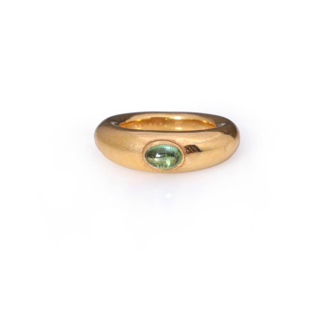 Vintage 18K Gold & Tourmaline Ring by Chaumet: A fine vintage 18k yellow gold ring by Chaumet, Paris; set with a oval green tourmaline cabochon in oval bezel, the interior of the ring marked CHAUMET PARIS 153955-750, with two French touch marks to