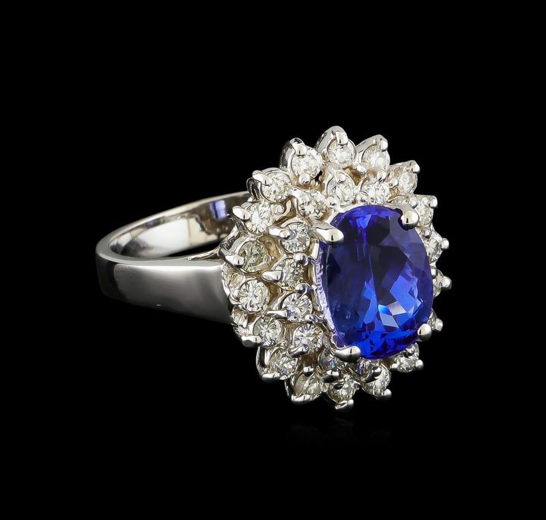 2.13 ctw Tanzanite and Diamond Ring - 14KT White Gold: One electronically tested 14KT white gold lady's cast fashion ring with a double basket halo with a bright polish finish. The featured lady's ring has a shank measuring 2.80 millimeters wide. Identifi