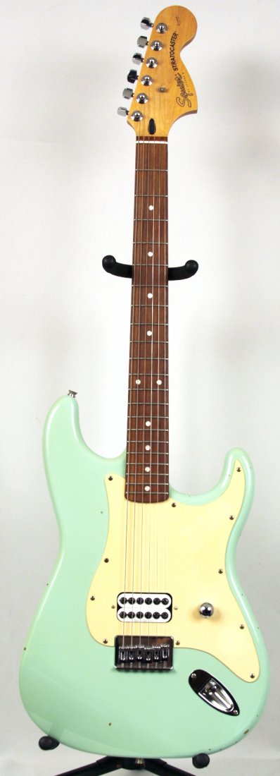 Squier Stratocaster by Fender Tom Delonge Duncan Design: Squier Stratocaster by Fender Tom Delonge Duncan Designed in Seafoam DGUI58. As-Is Condition! WG781PL. This very cool Fender Squier Seafoam finished Tom Delonge Duncan designed one pickup Strat is the