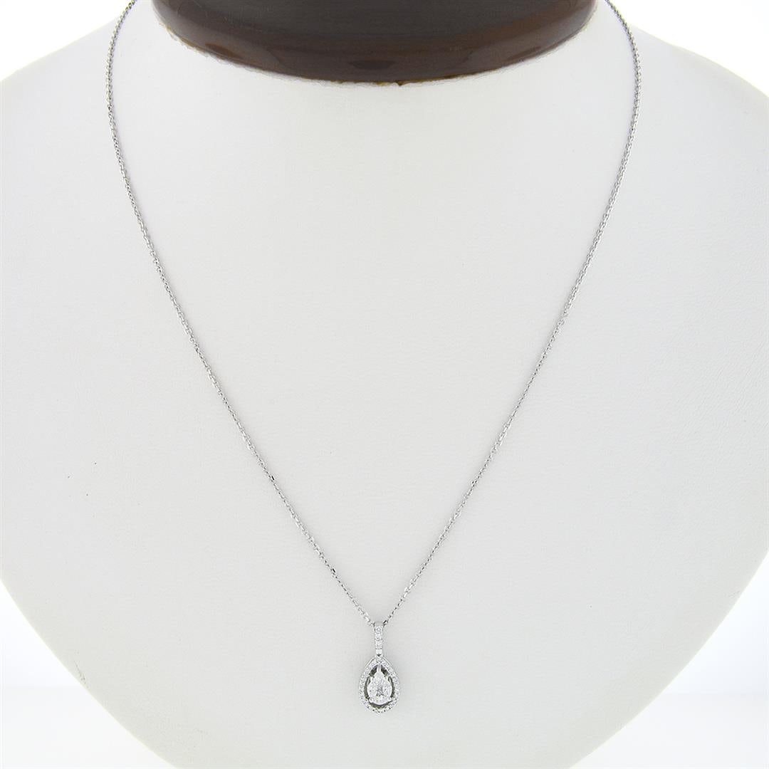 14K White Gold Diamond Tear Drop Pear Solitaire Cluster Petite Pendant Necklace: A solid 14k white gold tear drop pendant necklace, with 28 round brilliant cut natural diamonds (VS2/SI1 ; G/H - 0.32ctw), and 1 Pear Cut 3 Marquise Cut 2 Princess Cut Natural diamonds (SI1/SI2 ; G/H 