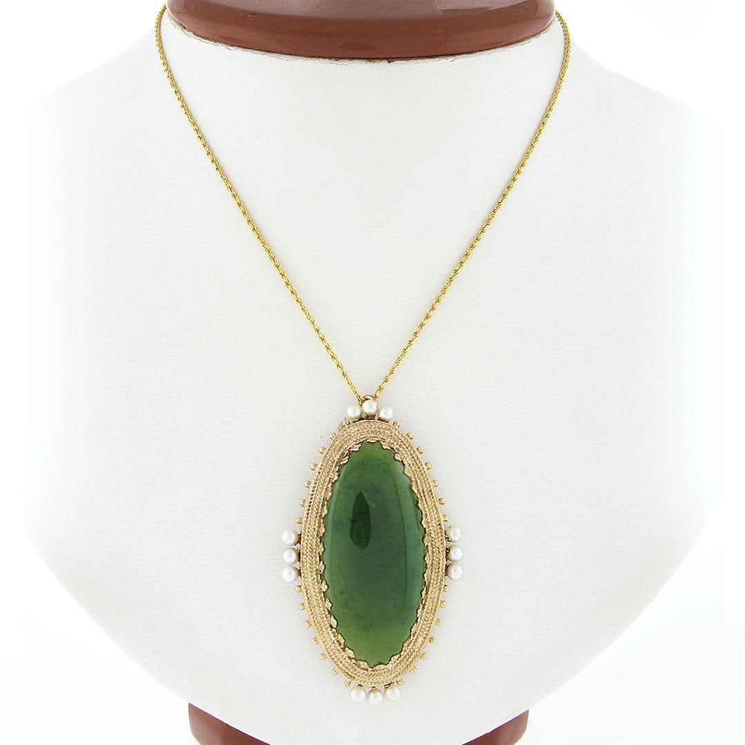 Vintage 14k Gold Large Oval Cabochon Jade Pearl Twisted Wire Halo Brooch Pendant: A vintage solid 14k yellow gold pin brooch pendant necklace, with 1 oval cabochon cut natural jade (39.5x18.9mm), and 12 round shape cultured pearls (3.1mm each). 20 inch rope link chain, 19.17 grams