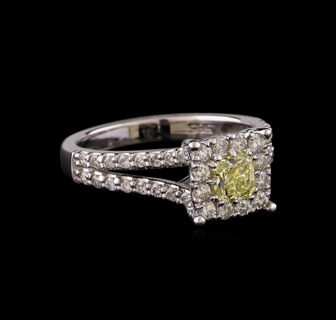 1.09 ctw Fancy Yellow Diamond Ring - 14KT White Gold: One electronically tested 14KT white gold lady's cast wedding ring with a split shank halo with a bright polish finish. The featured lady's ring has a shank measuring 2.47 millimeters wide. Identified