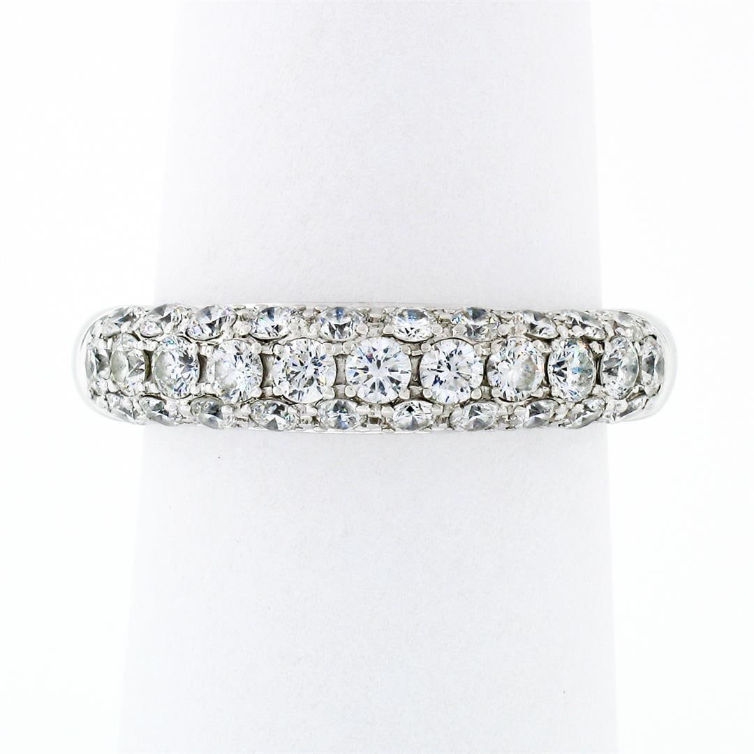 Fancy 18K White Gold 1.15 ctw Round Pave Diamond 4.75mm Domed Wedding Band Ring: An estate solid 18k white gold band ring, with 31 round brilliant cut natural diamonds ( F/G- VS2/SI1; 1.15ctw). The ring is size 6.5, weighs a total of 5.25 grams, and measures 4.75mm wide.