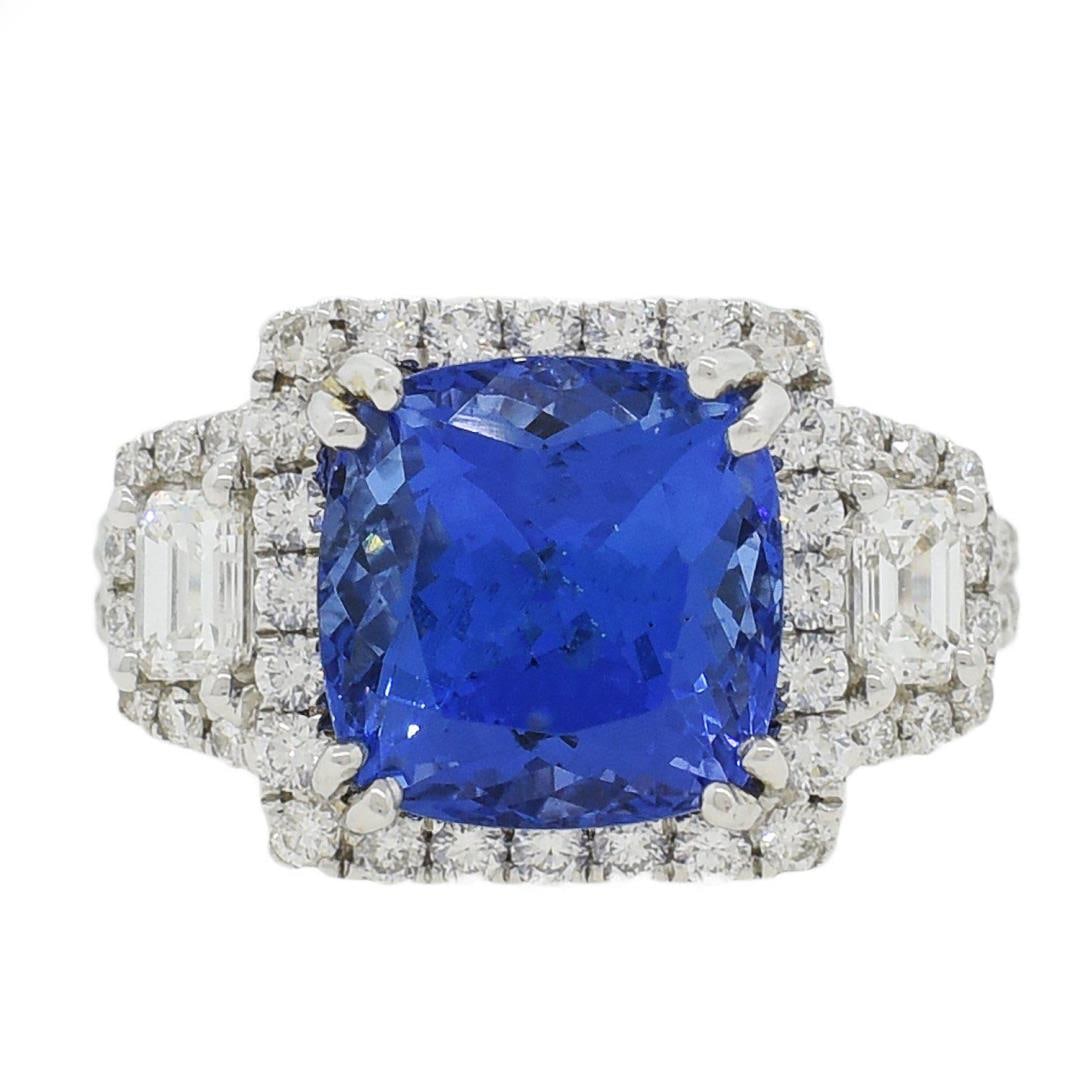 5.56 ctw Tanzanite and 1.42 ctw Diamond 18KT White Gold Ring: One electronically tested 18KT white gold ladies cast tanzanite and diamond ring with a bright polish finish. Condition is new, good workmanship. The featured tanzanite is set within a diamond bezel s