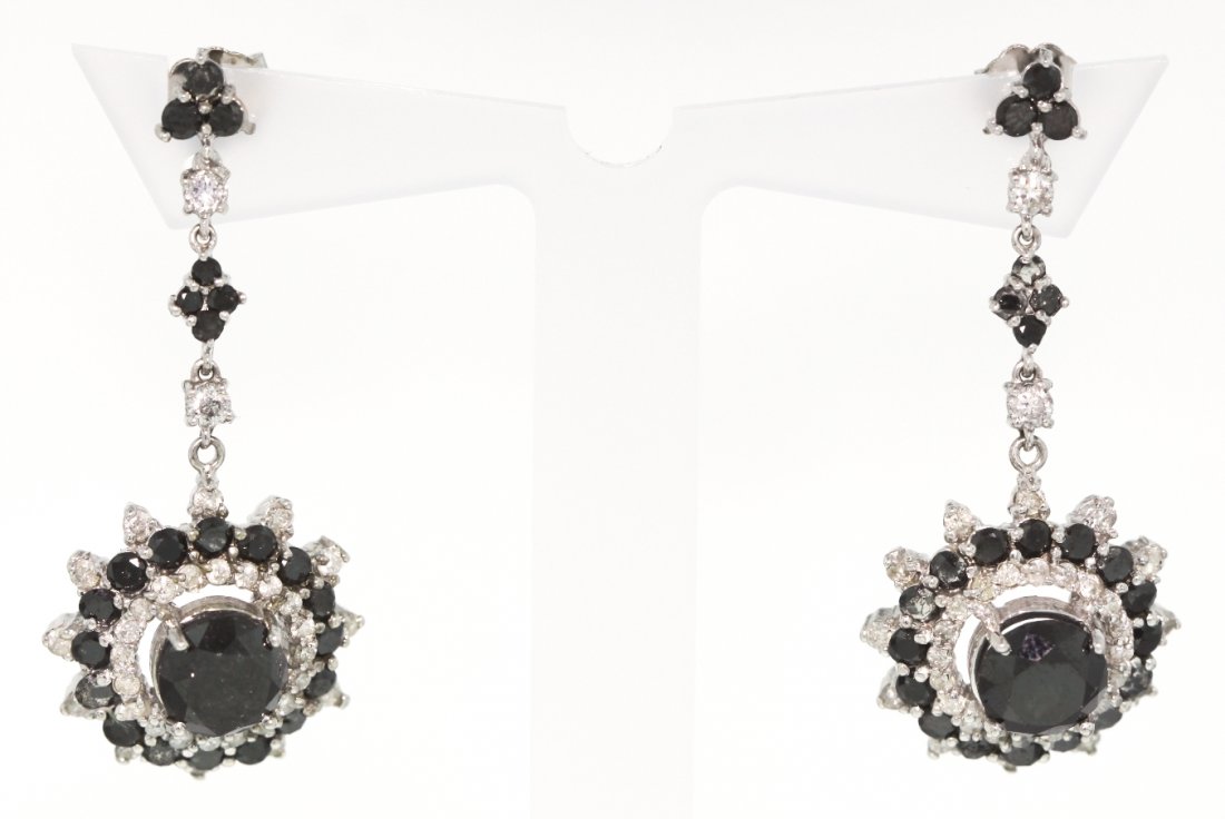 14KT White Gold 6.47ct Black and White Diamond Earrings: 14KT White Gold 6.47ct Black and White Diamond Earrings RM423. New Condition! GQ1721SG. One lady's polished, stamped and electronically tested solid 14KT white gold pair of earrings mounted with: 2 la
