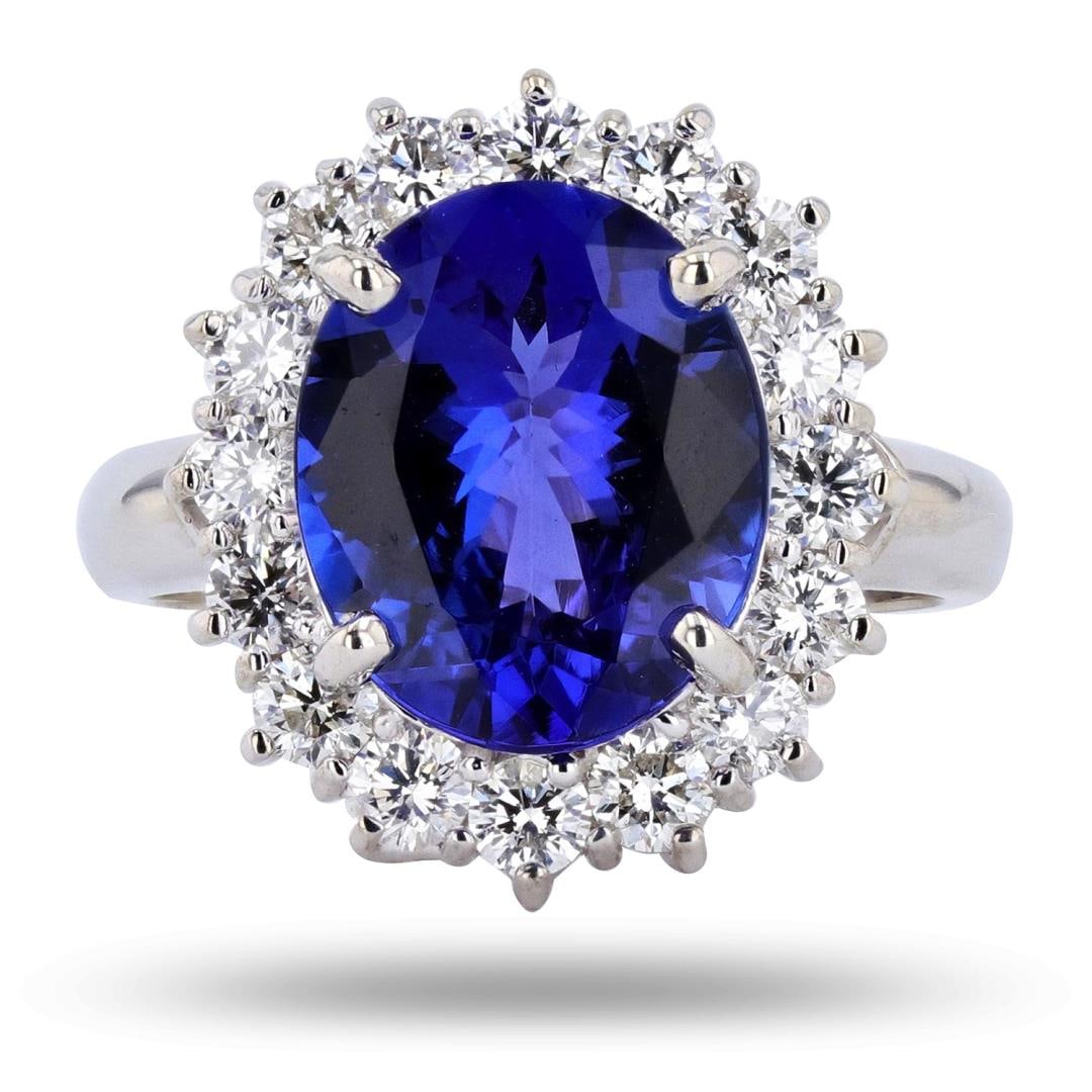 4.18 ctw Tanzanite and 1.03 ctw Diamond 14K White Gold Ring: One polished, and tested, 14K white gold ring with a bright finish. The ring is mounted with: 1 genuine tanzanite center stone weighing approximately 4.18 carat, and 16 genuine round diamonds weighing