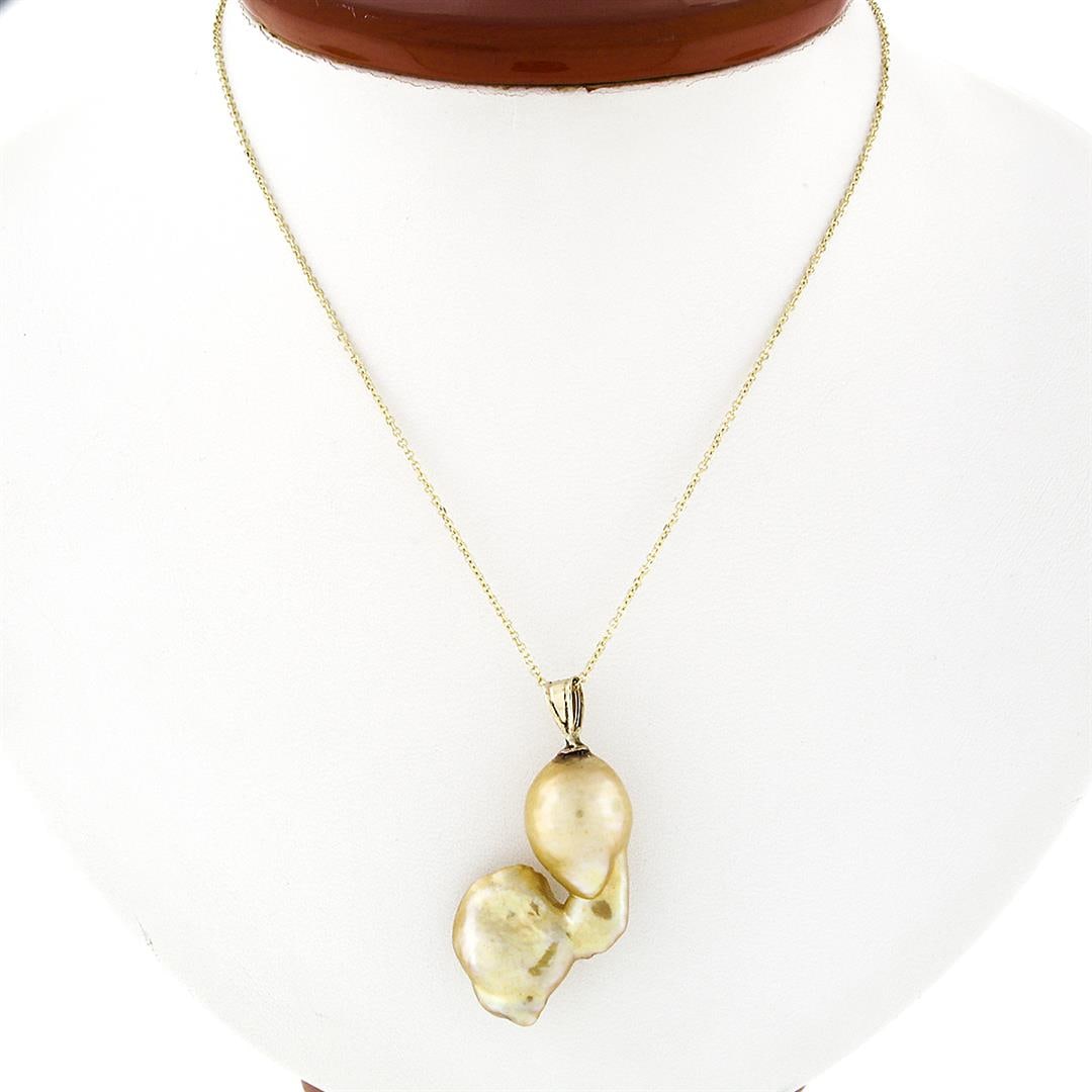 Vintage 14K Yellow Gold Large Baroque Pearl Solitaire Pendant 18" Chain Necklace: A vintage solid 14k yellow gold freeform pendant necklace, featuring 1 baroque shape natural pearl. 18 inch cable link chain, 7.57 grams total weight, pendant measures 39.4x20.4mm.