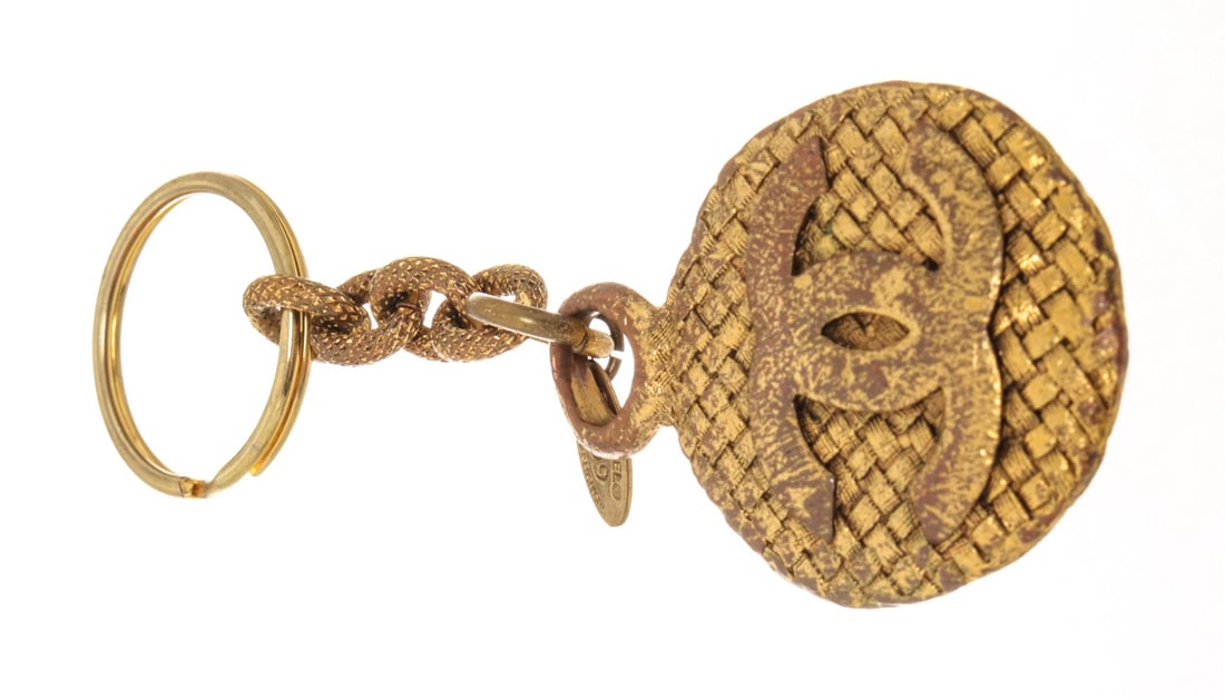 Chanel Gold-tone Metal Keyholder: One Chanel Gold-tone Metal Keyholder. Item is sold AS-IS. All available information is listed in the description and shown in the photo. Chanel gold-tone metal keyholder with CC logo coin with a weave