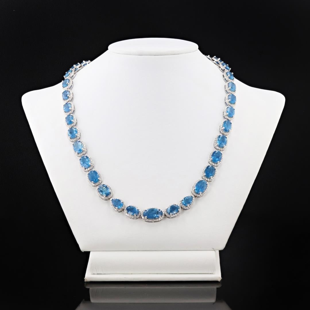 42.30 ctw Aquamarine and 8.01 ctw Diamond 14K White Gold Necklace: Fourteen karat (14K) white gold natural aquamarine beryl and diamond necklace. Twenty nine (29) oval and pear cut natural aquamarine beryl gemstones are mounted in the center of the necklace. Round br