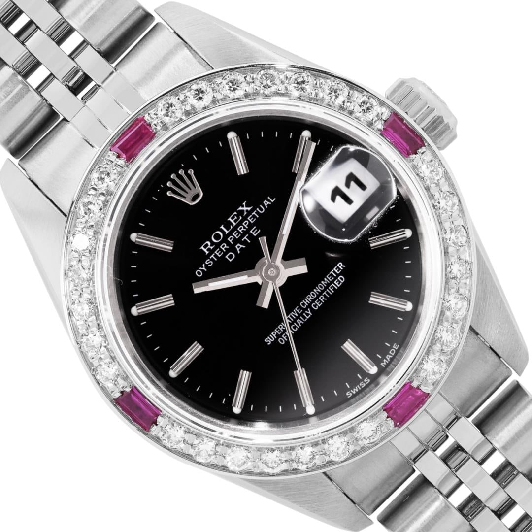Rolex Ladies Stainless Steel Black Index Dial Diamond And Ruby Bezel Date Wristw: One Rolex Ladies Pre Owned Quickset Stainless Steel Date Wristwatch Polished Bright with Satin Finish, Serviced And Electronically Tested, Stainless Steel Case: 26mm, Stainless Steel Crown, Custom Bez