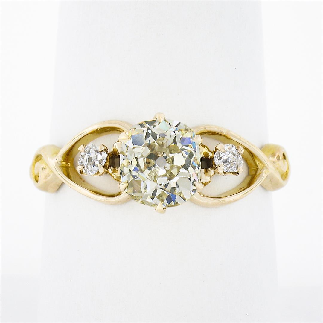 Antique Victorian 10k Gold 1.39 ctw Diamond 3 Stone w/ Open Sides Engagement Rin: An antique solid 10k yellow gold engagement ring, with 1 old mine cut natural diamond (O/P - SI1 ; 1.29ct), accented with 2 old mine cut natural diamonds (G/H - VS2/SI1 ; 0.10ctw). The ring is size 8.