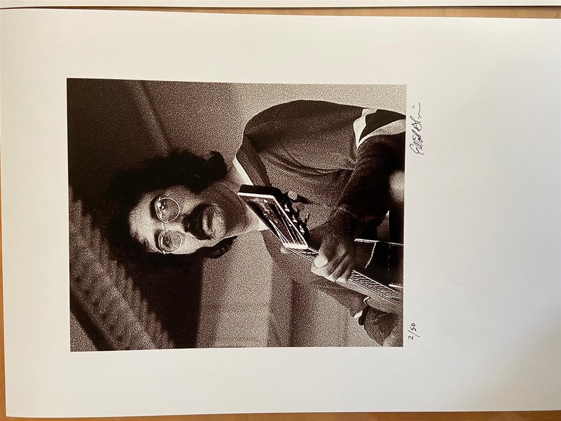 Jerry Garcia, close-up by Elliot Blinder: A hand-signed & numbered glossy photograph shot in 1969 for Rolling Stone by photographer/author Elliot Blinder. Image is 10x8" on 18x22" paper. Shot backstage at The Boston Tea Party club. Edition of