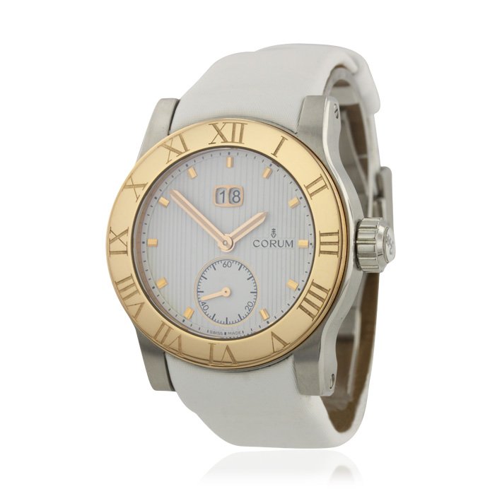 Corum Romulus Large Date 18KT Rose Gold Bezel Wristwatc: Corum Romulus Large Date 18KT Rose Gold Bezel Wristwatch GB799. Good Condition! NL9003UL. One gents, Corum Romulus Large Date, 2 Tone wristwatch electronically tested, Case: stainless steel, 42mm diam