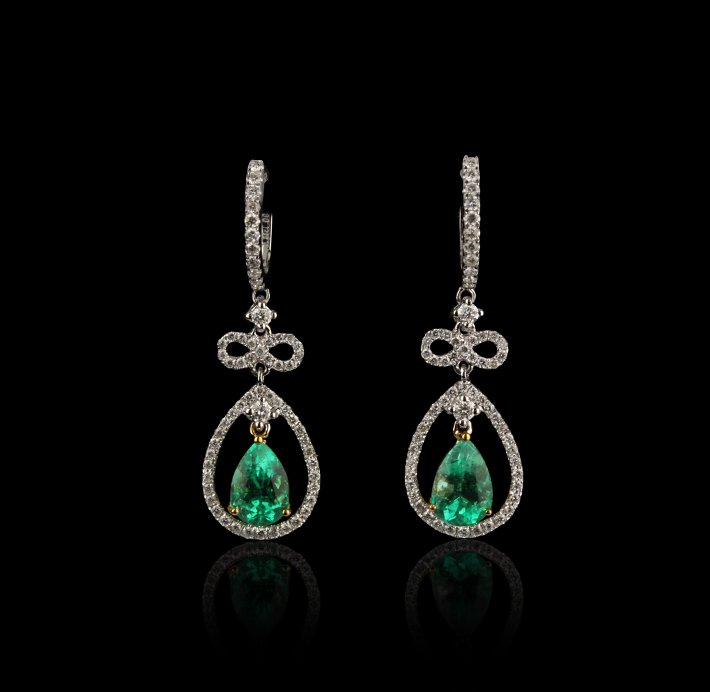 18KT White Gold 1.88ctw Emerald and Diamond Earrings FJ: 18KT White Gold 1.88ctw Emerald and Diamond Earrings FJM2138. Excellent Condition! RS9361TP. One pair of earrings featuring: 3.90gm of 18KT white gold, (2) emeralds with a total weight of 1.88cts and 