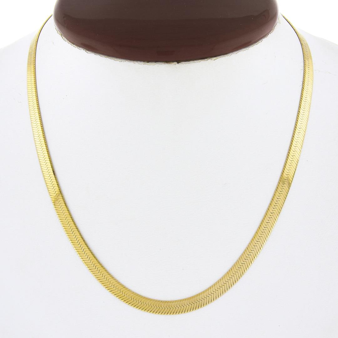 Italian 14k Gold 4.65mm 16" Polished Fancy Flat Herringbone Link Chain Necklace: A solid 14k yellow gold herringbone link necklace. It weighs a total of 11.75 grams, measures 4.65mm wide, and measures 16 inches in length.