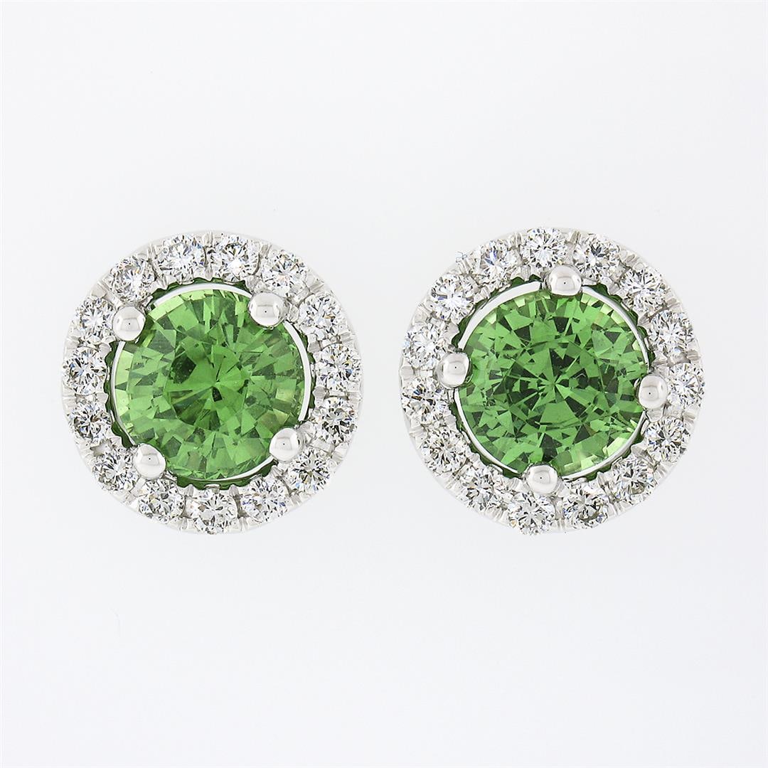 NEW 18k White Gold 2.55 ctw Round Brilliant Tsavorite Stud Earrings & Diamond Ha: A new solid 14k white gold pair of stud earrings, with 2 round brilliant cut natural tsavorites (2.12ctw ), surrounded with a halo of 30 round brilliant cut natural diamonds (F/G - VS1/VS2 ; 0.43ctw).
